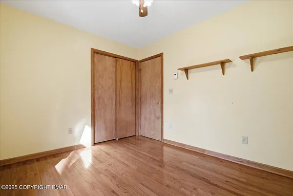 a view of an empty room with wooden floor