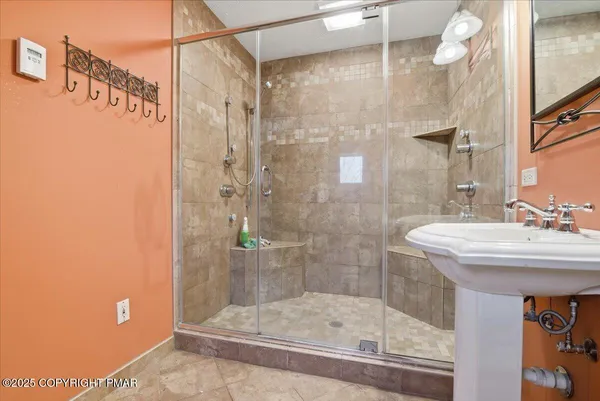 a bathroom with a shower and sink
