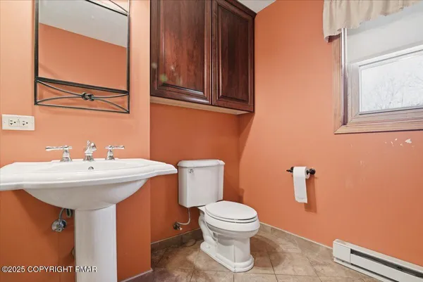 a bathroom with a sink a toilet and mirror