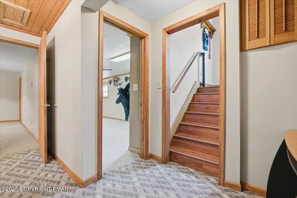 a view of a hallway with wooden floor and entryway