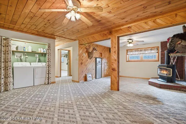 a view of a livingroom with wooden floor and a ceiling fan