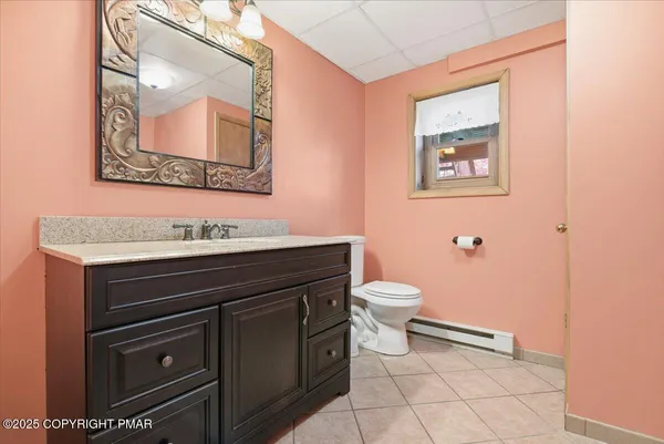 a bathroom with a toilet a sink and mirror