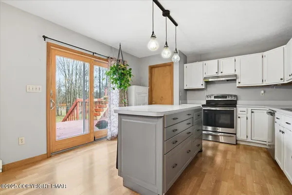 a kitchen with white cabinets and white appliances