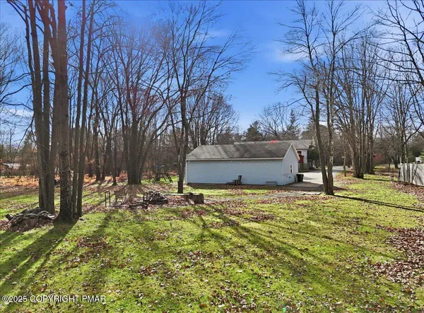 a backyard of a house with large trees