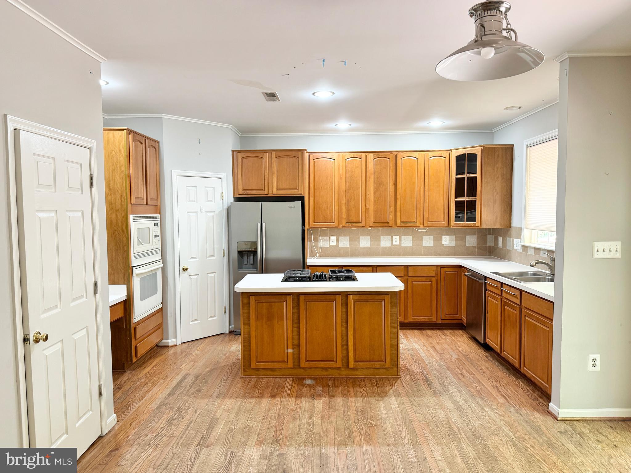 3721 Katie Place Triangle, VA 22172 - Photo 6 of 39 a kitchen with stainless steel appliances granite countertop a sink stove and refrigerator