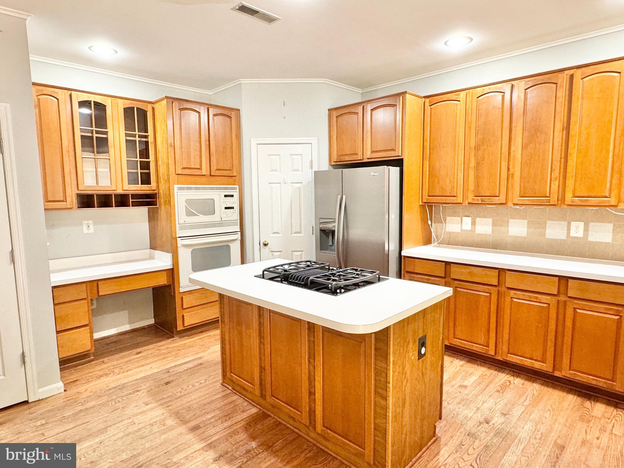 3721 Katie Place Triangle, VA 22172 - Photo 8 of 39 a kitchen with stainless steel appliances granite countertop a stove top oven a refrigerator a sink and dishwasher with a dining table