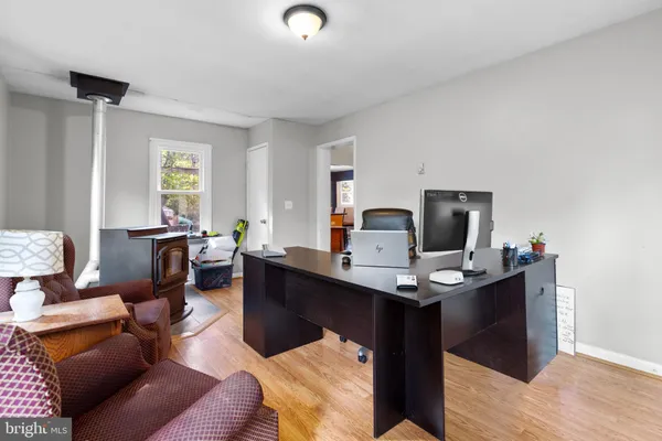 a view of a workspace with furniture and a window