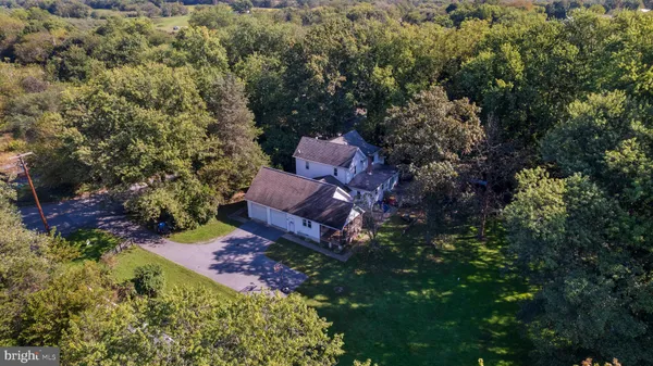 an aerial view of a house with a yard