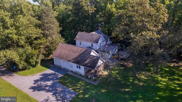 a aerial view of a house with a yard basket ball court and outdoor seating