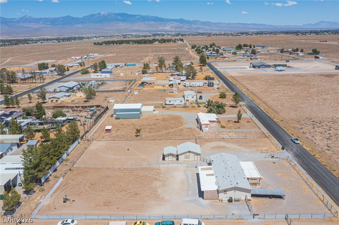 3200 Maple Road Pahrump, NV 89048 - Photo 50 of 53 A sprawling rural property with multiple structures set against a mountainous backdrop.