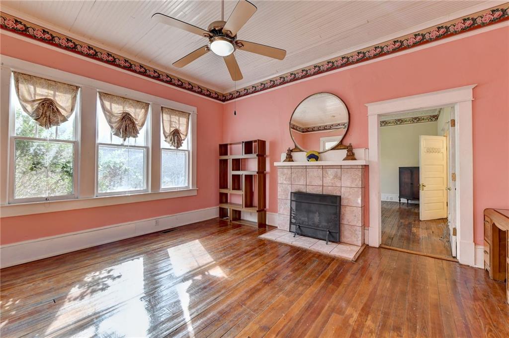 221 Plainview Road Jefferson, GA 30549 - Photo 22 of 87 a view of an empty room with wooden floor fireplace and a window