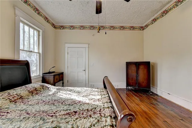 a bedroom with a bed a fireplace and a window