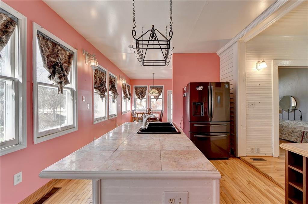 221 Plainview Road Jefferson, GA 30549 - Photo 39 of 87 a kitchen with stainless steel appliances granite countertop a refrigerator a oven a stove and a sink with wooden floor