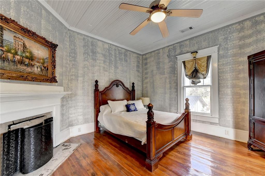 221 Plainview Road Jefferson, GA 30549 - Photo 47 of 87 a bedroom with a bed a fireplace and a window