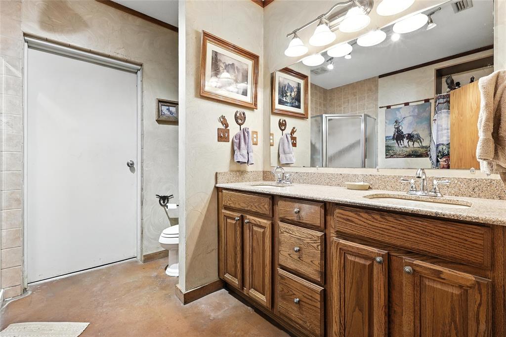 12370 Fortenberry Road Sanger, TX 76266 - Photo 14 of 40 Bathroom with double vanity, a stall shower, and concrete flooring