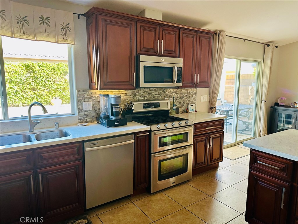 67810 Ontina Road Cathedral City, CA 92234 - Photo 14 of 43 a kitchen with a sink stove and microwave