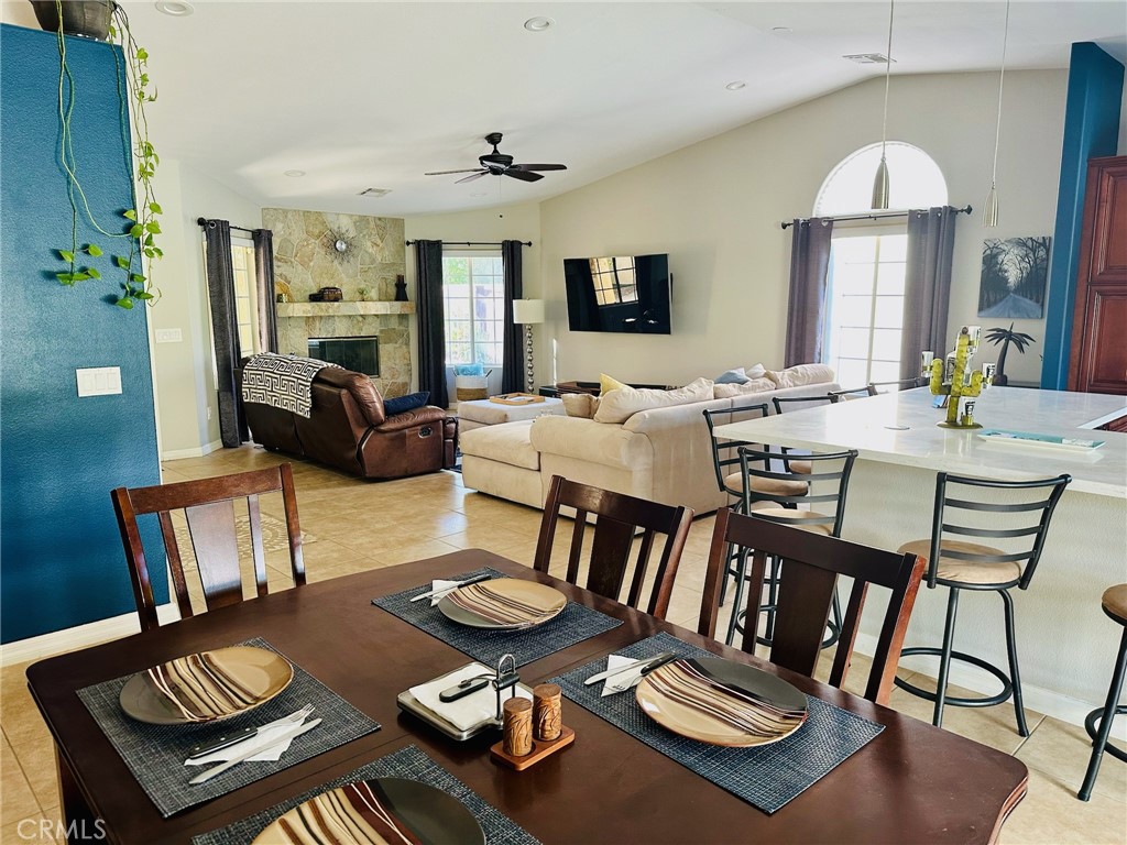 67810 Ontina Road Cathedral City, CA 92234 - Photo 17 of 43 a view of a dining room with furniture a chandelier and wooden floor