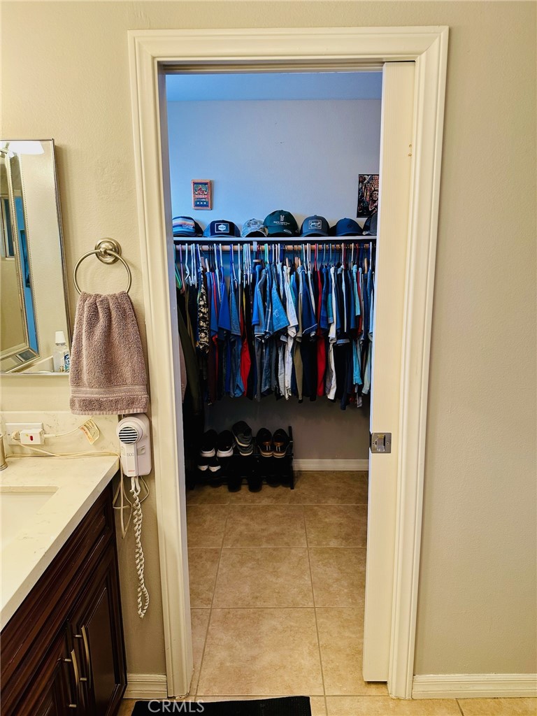 67810 Ontina Road Cathedral City, CA 92234 - Photo 26 of 43 a view of walk in closet with clothes and shoes