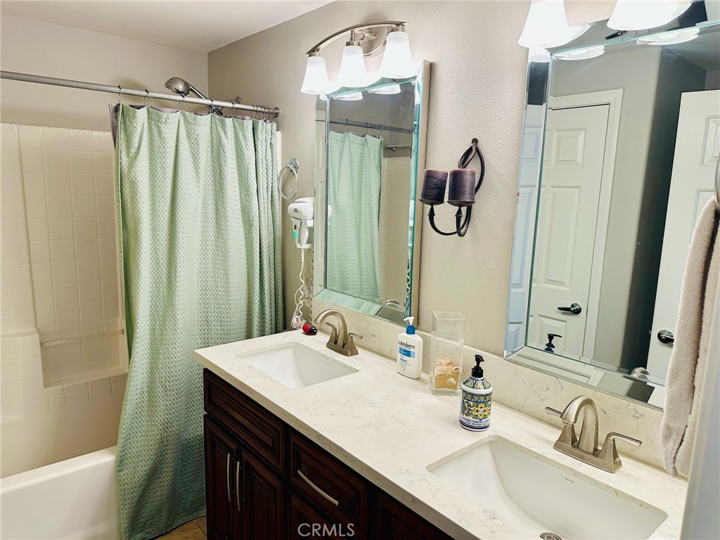 67810 Ontina Road Cathedral City, CA 92234 - Photo 30 of 43 a bathroom with a granite countertop sink and a mirror