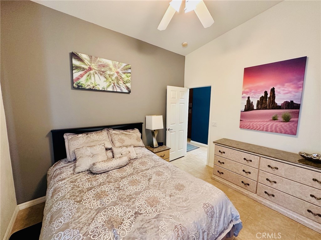 67810 Ontina Road Cathedral City, CA 92234 - Photo 35 of 43 a bedroom with a bed and a flat screen tv
