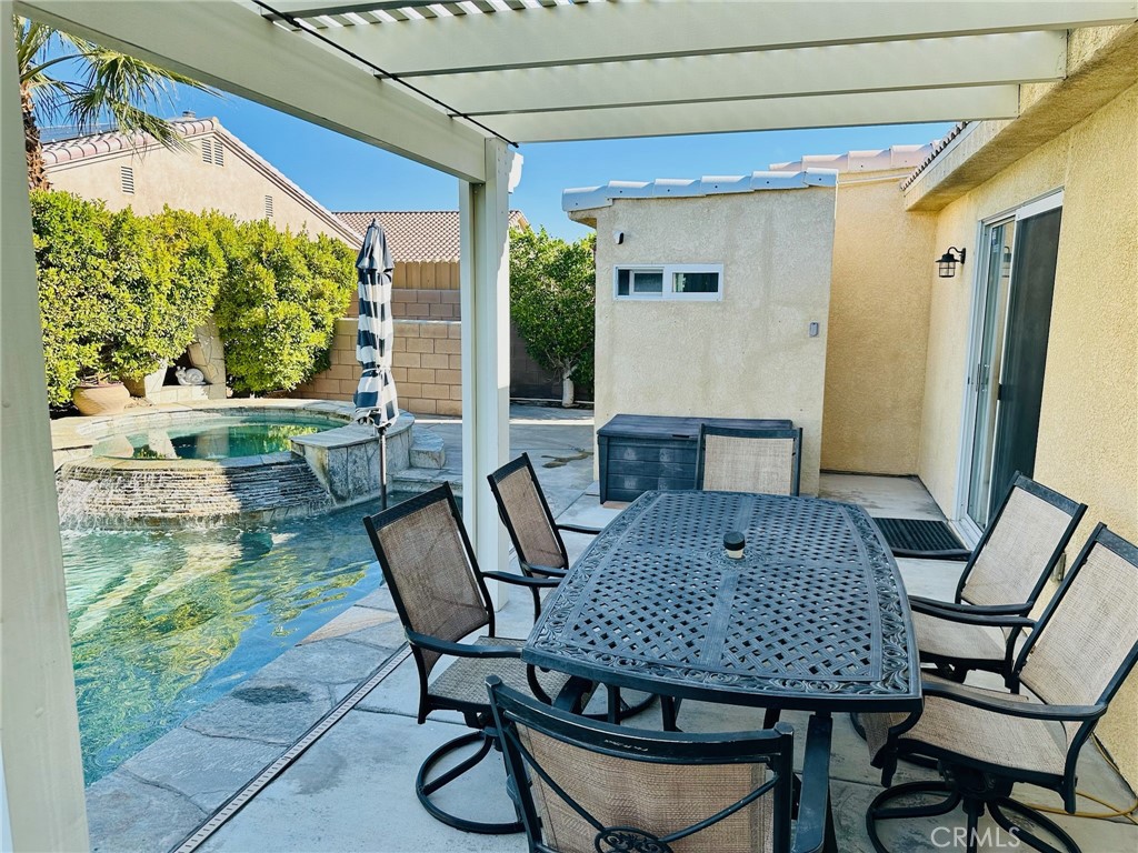 67810 Ontina Road Cathedral City, CA 92234 - Photo 38 of 43 a view of a patio with table and chairs and potted plants