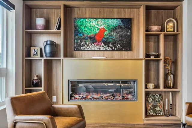 a living room with furniture and a dining table with kitchen view