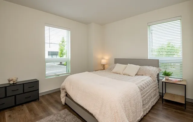 a bedroom with a bed and a window