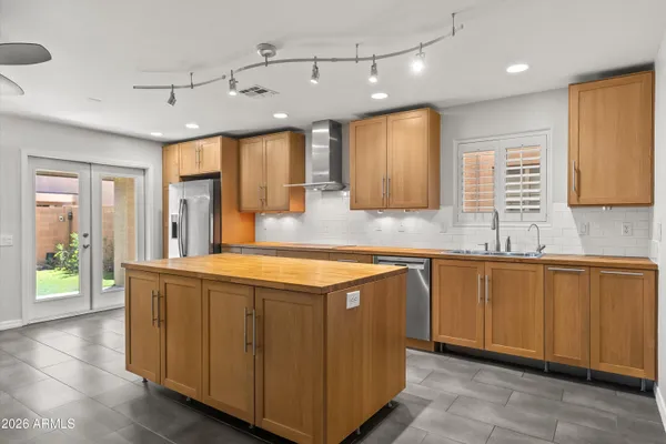a kitchen with stainless steel appliances granite countertop a sink and a stove