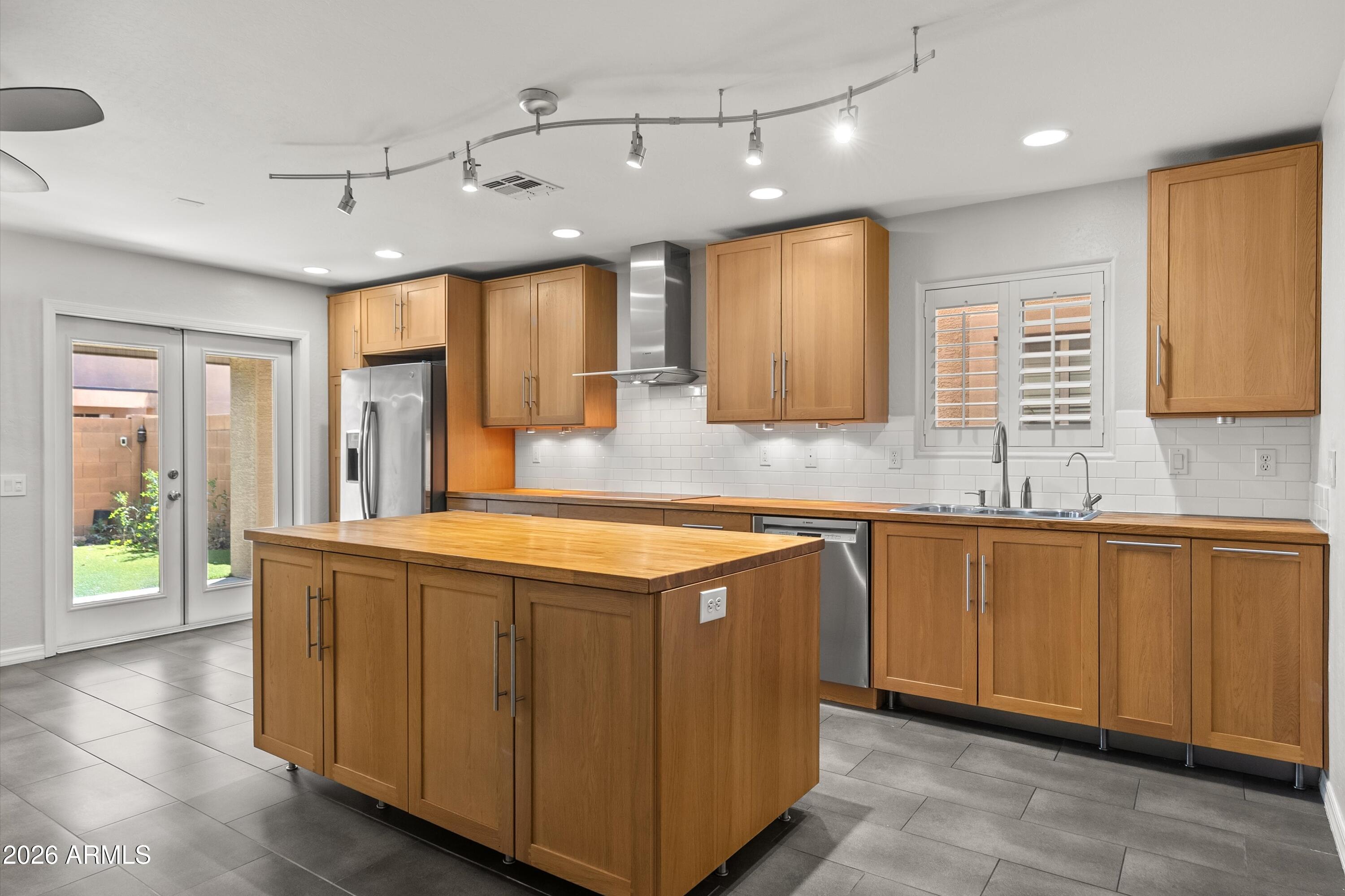 a kitchen with stainless steel appliances granite countertop a sink and a stove