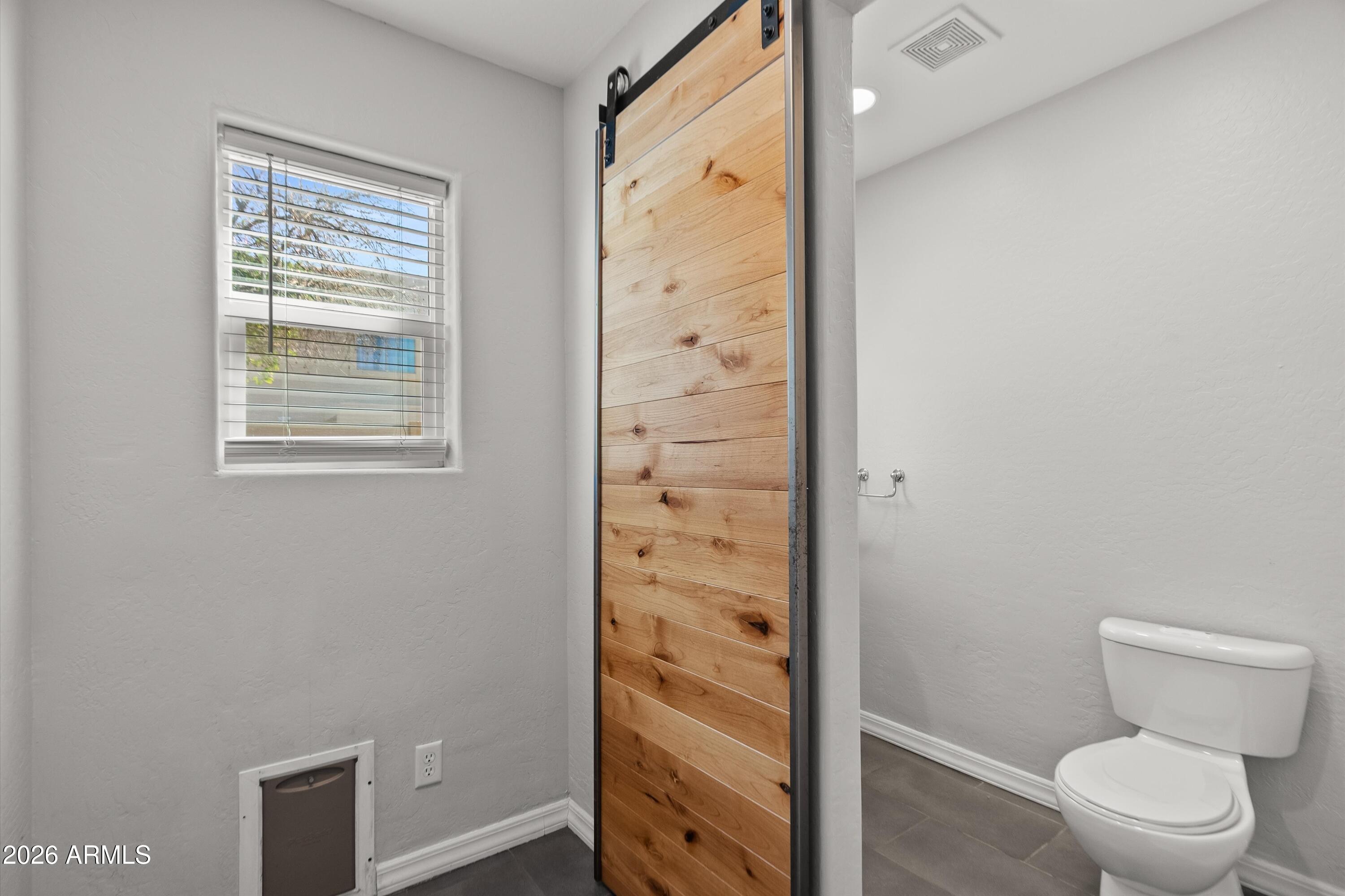 15649 North 29th Place Phoenix, AZ 85032 - Photo 14 of 35 a bathroom with a toilet and a shower