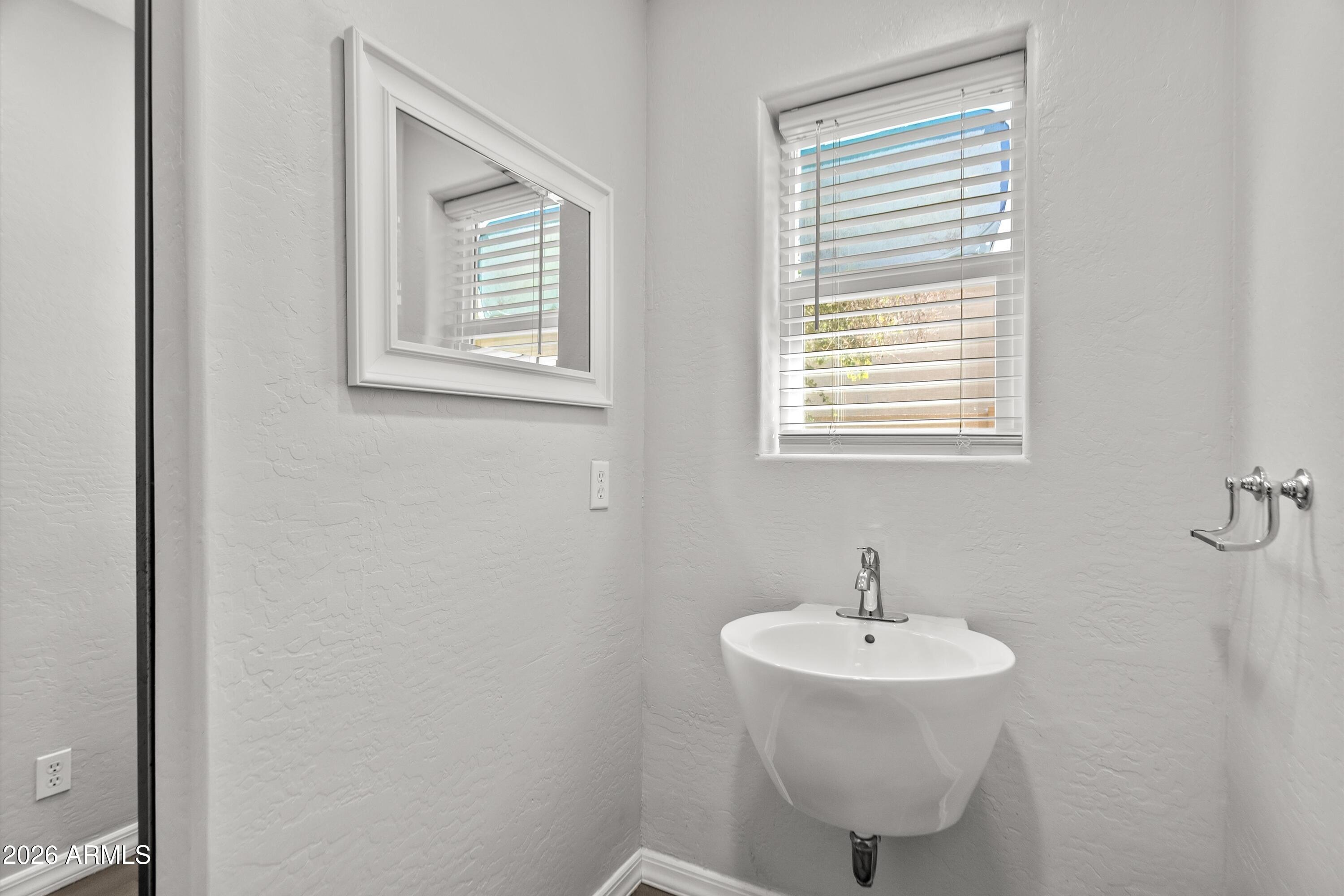 15649 North 29th Place Phoenix, AZ 85032 - Photo 15 of 35 a bathroom with a sink and a window