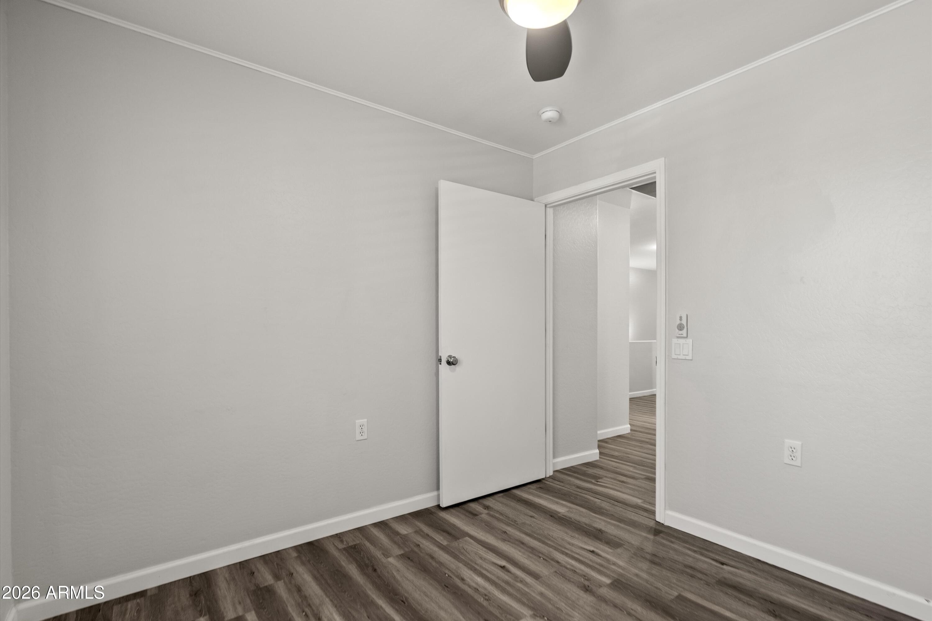 15649 North 29th Place Phoenix, AZ 85032 - Photo 29 of 35 a view of an empty room with wooden floor