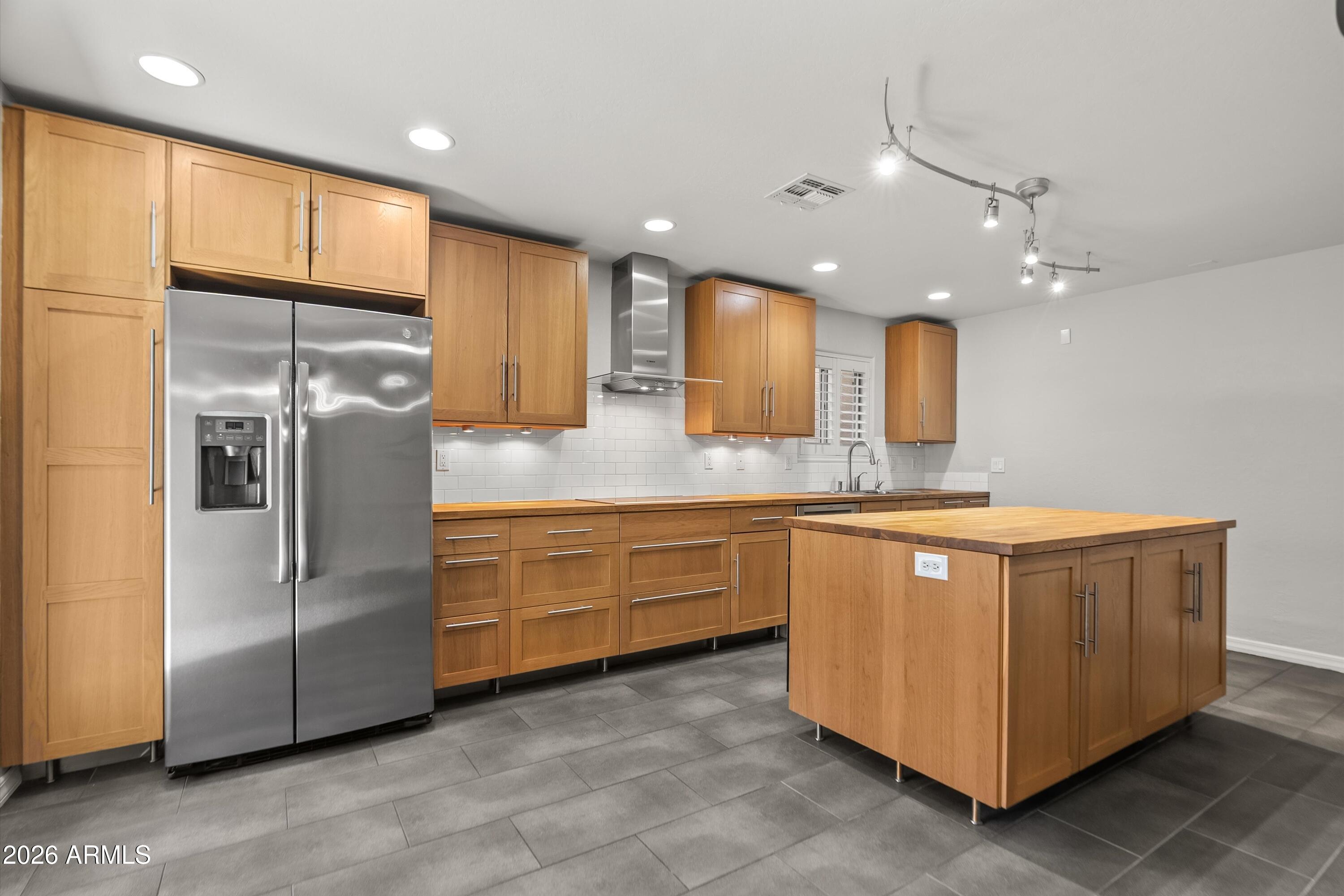 15649 North 29th Place Phoenix, AZ 85032 - Photo 4 of 35 a modern kitchen with stainless steel appliances granite countertop a refrigerator and a sink