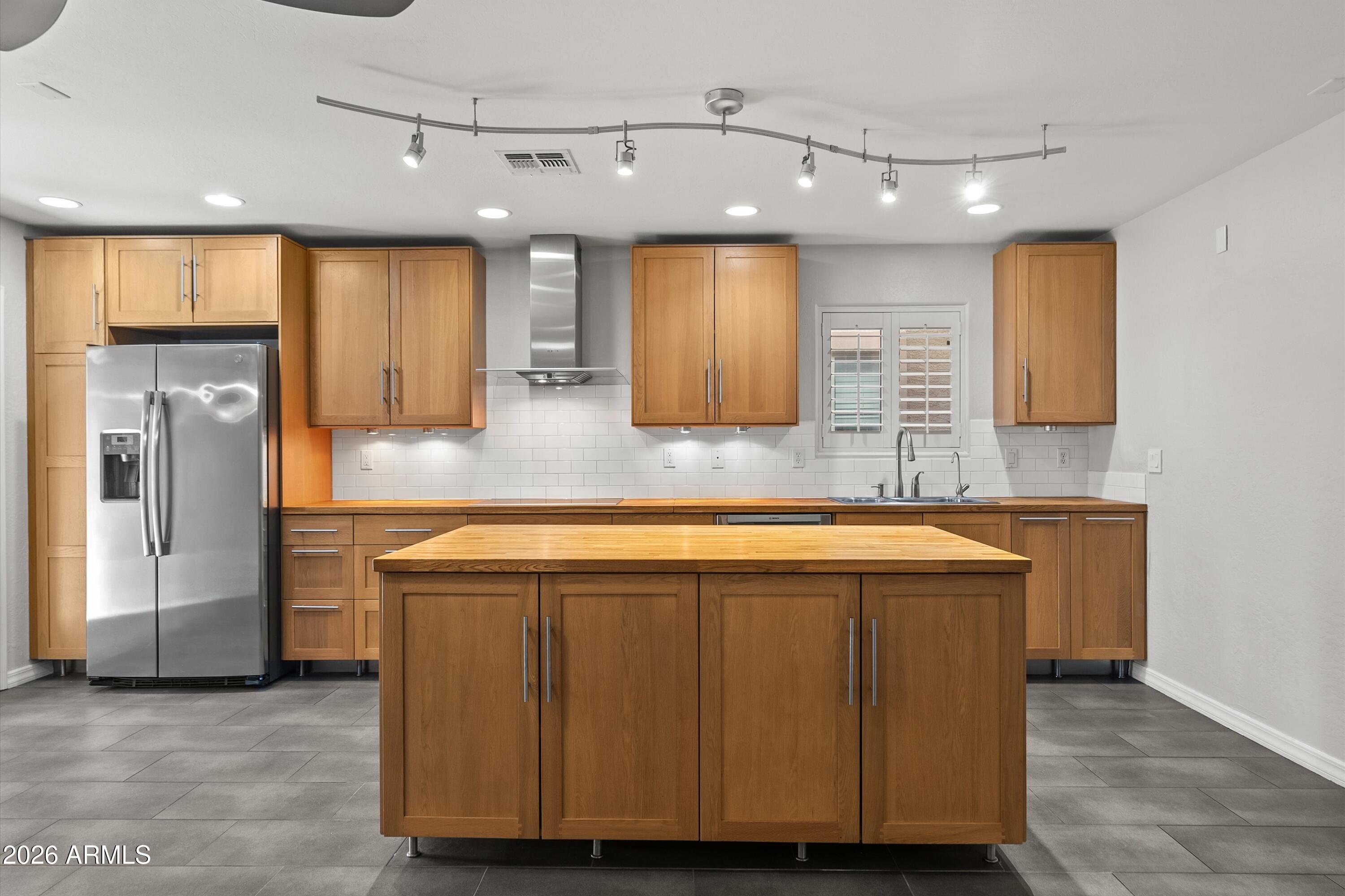 15649 North 29th Place Phoenix, AZ 85032 - Photo 5 of 35 a view of a kitchen with a sink and a refrigerator