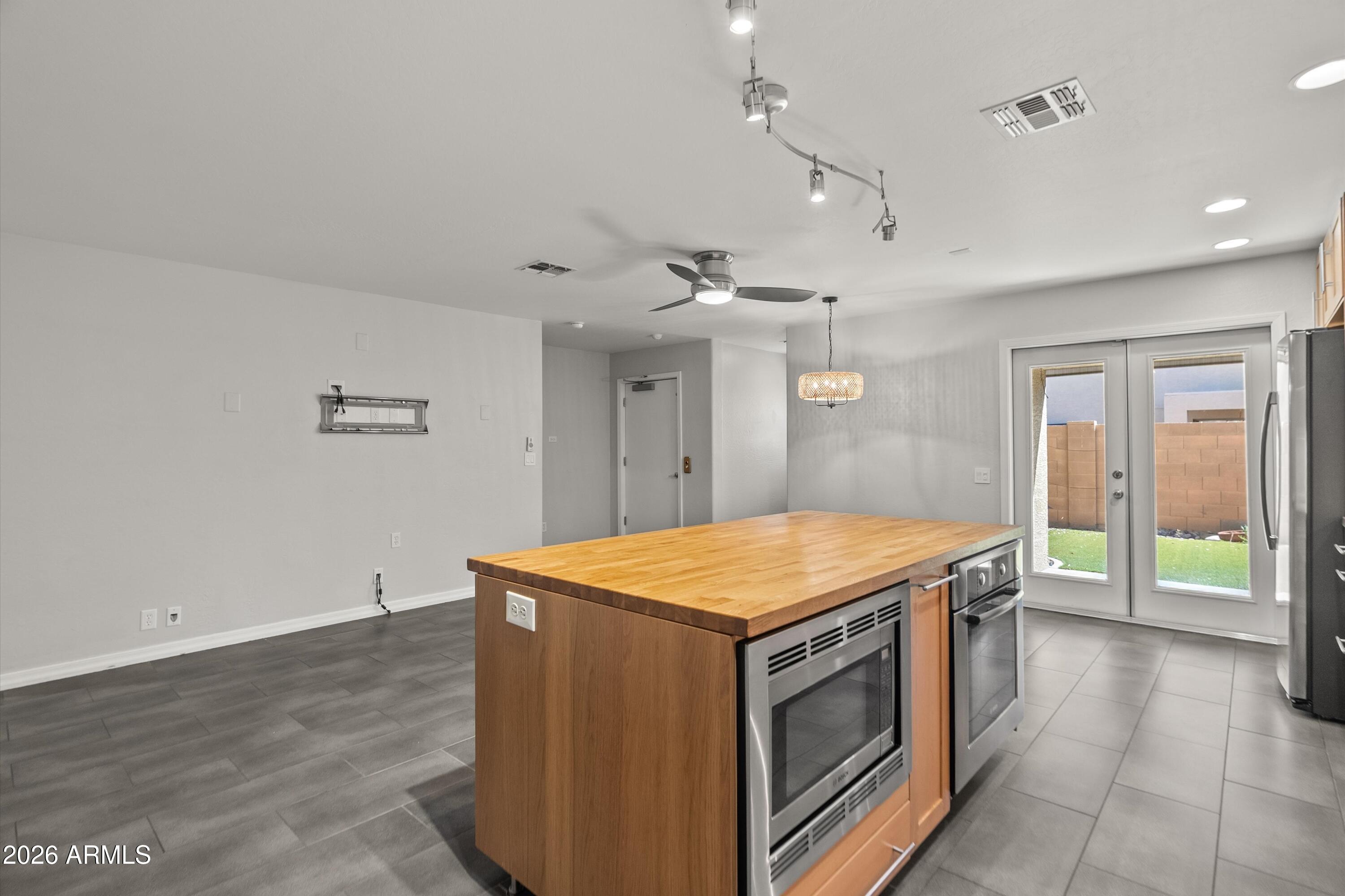 15649 North 29th Place Phoenix, AZ 85032 - Photo 8 of 35 a kitchen with a stove and a hallway