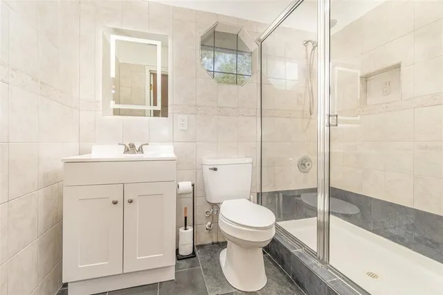 a bathroom with a sink toilet and shower