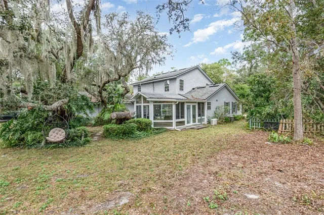 a view of a house with garden and trees