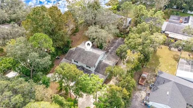 a aerial view of a house with yard and outdoor seating
