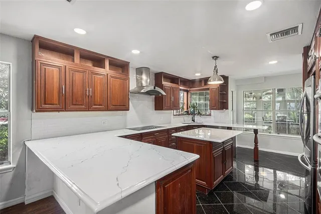 a kitchen with granite countertop a stove a table and chairs in it