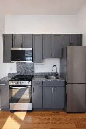 a kitchen with a sink a stove and refrigerator
