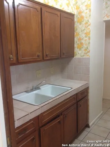 a white refrigerator freezer and a stove sitting inside of a kitchen