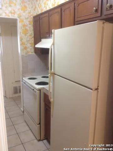 a kitchen with a stove and a refrigerator