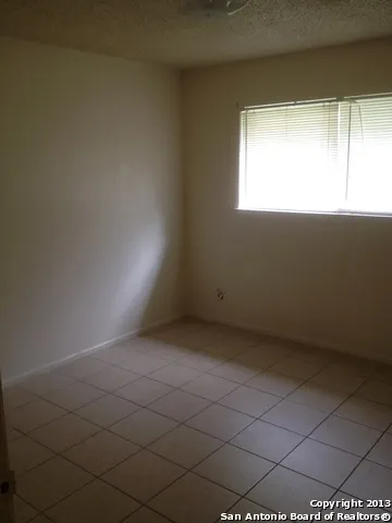 a bathroom with a granite countertop toilet and a bathtub