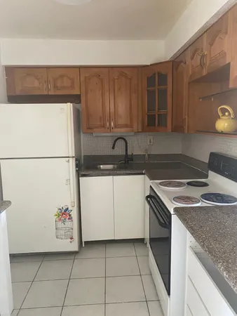 a kitchen with a sink a stove and a refrigerator