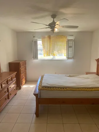 a bedroom with a bed and a desk