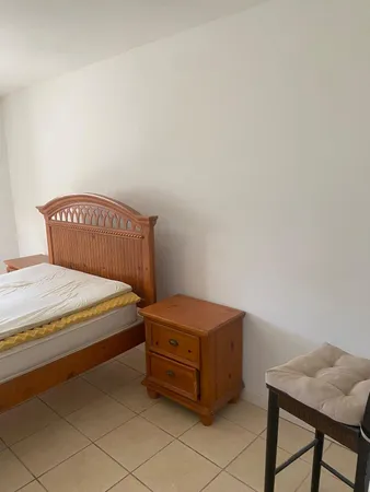 a white toilet sitting next to a bath tub