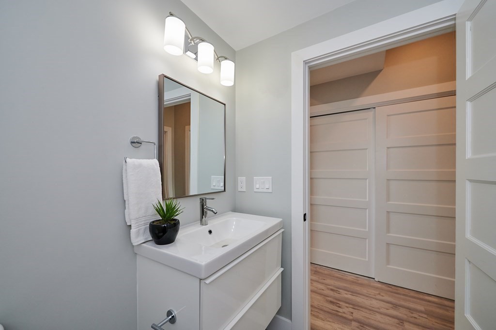 96 Cottage Street, Unit PARLOR Boston, MA 02128 - Photo 11 of 15 a bathroom with a sink and a mirror