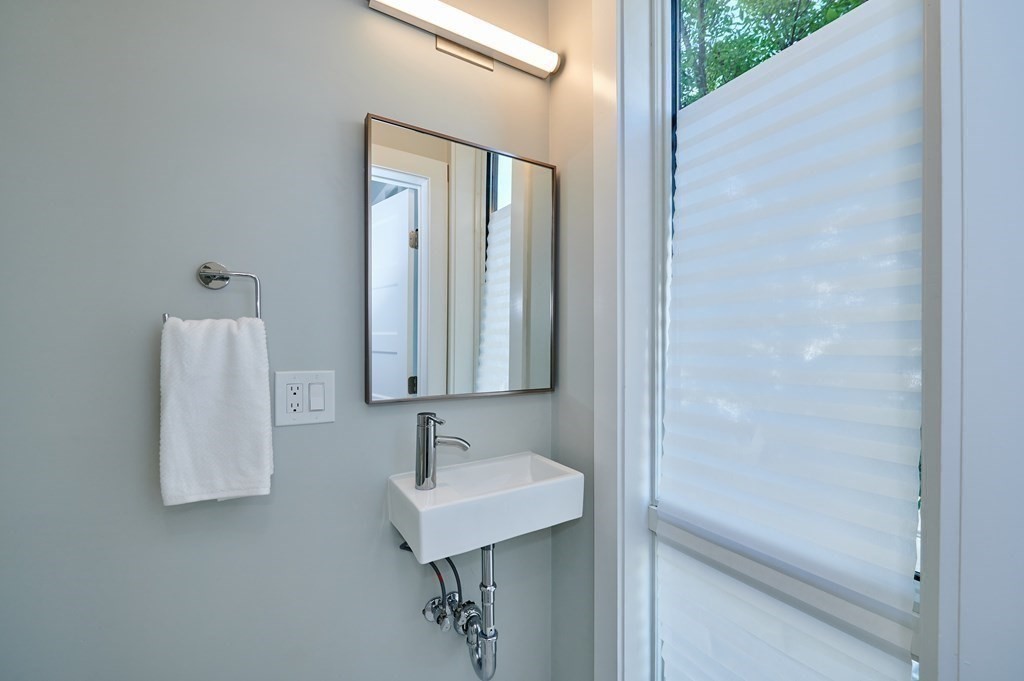 96 Cottage Street, Unit PARLOR Boston, MA 02128 - Photo 12 of 15 a bathroom with a sink and mirror
