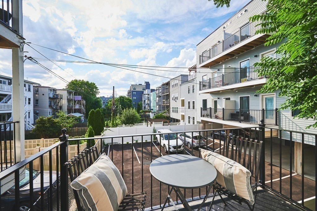 96 Cottage Street, Unit PARLOR Boston, MA 02128 - Photo 13 of 15 a balcony with table and chairs