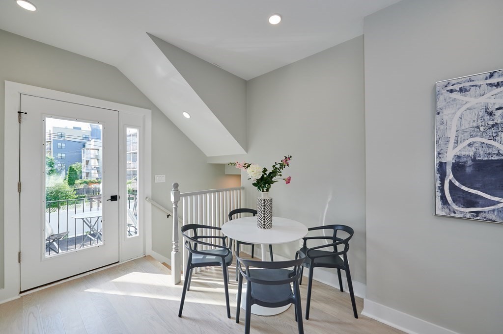 96 Cottage Street, Unit PARLOR Boston, MA 02128 - Photo 5 of 15 a view of a dining room with furniture and front door